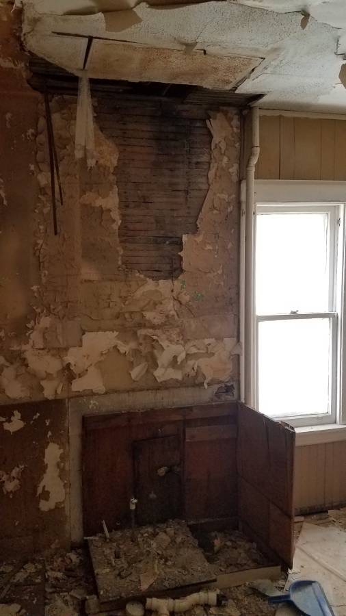Interior damaged wall before renovation